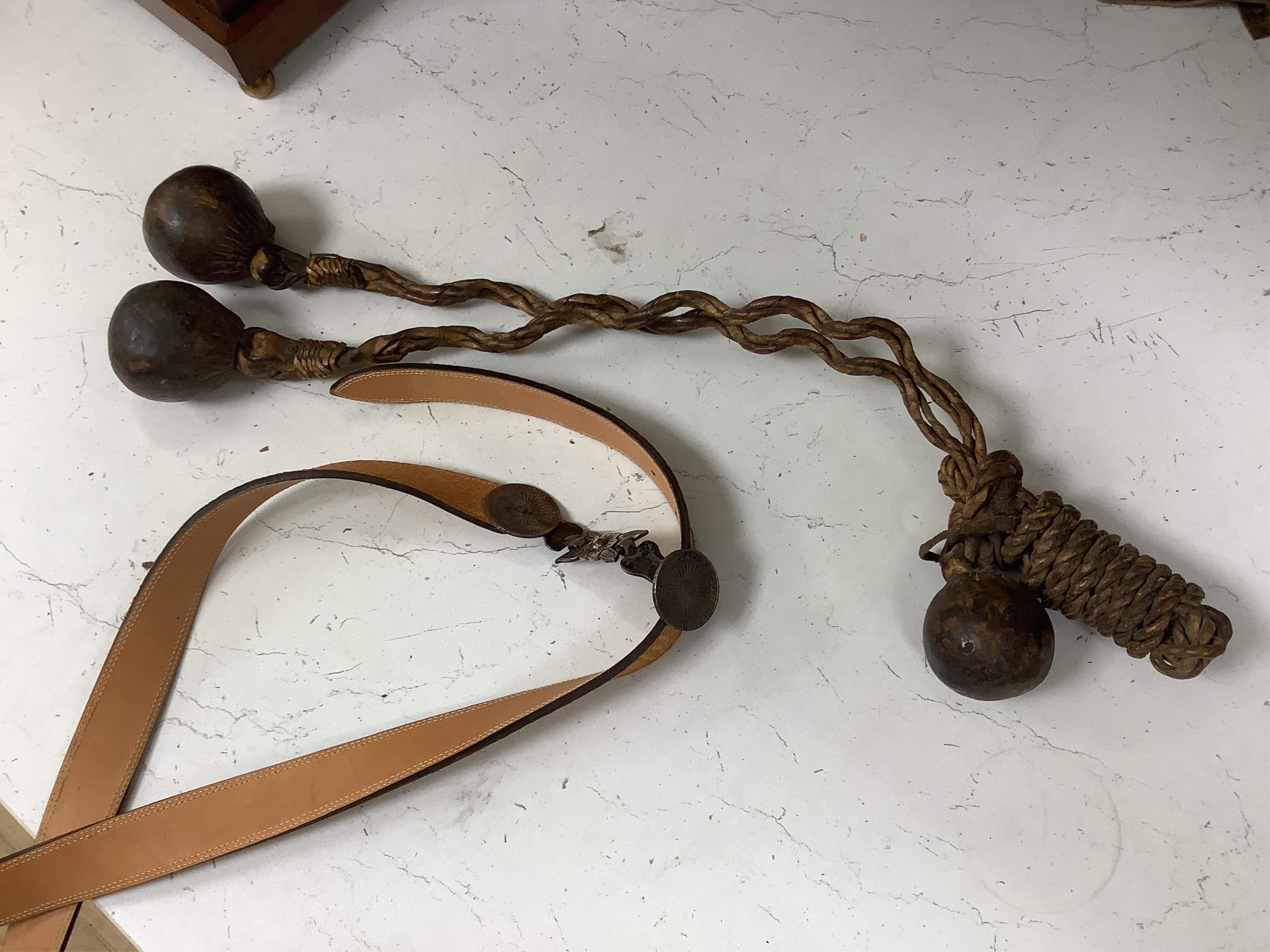 A group of Argentinian Gaucho spurs, bolas, bull whip, daggers and hanger, Longest 100cm